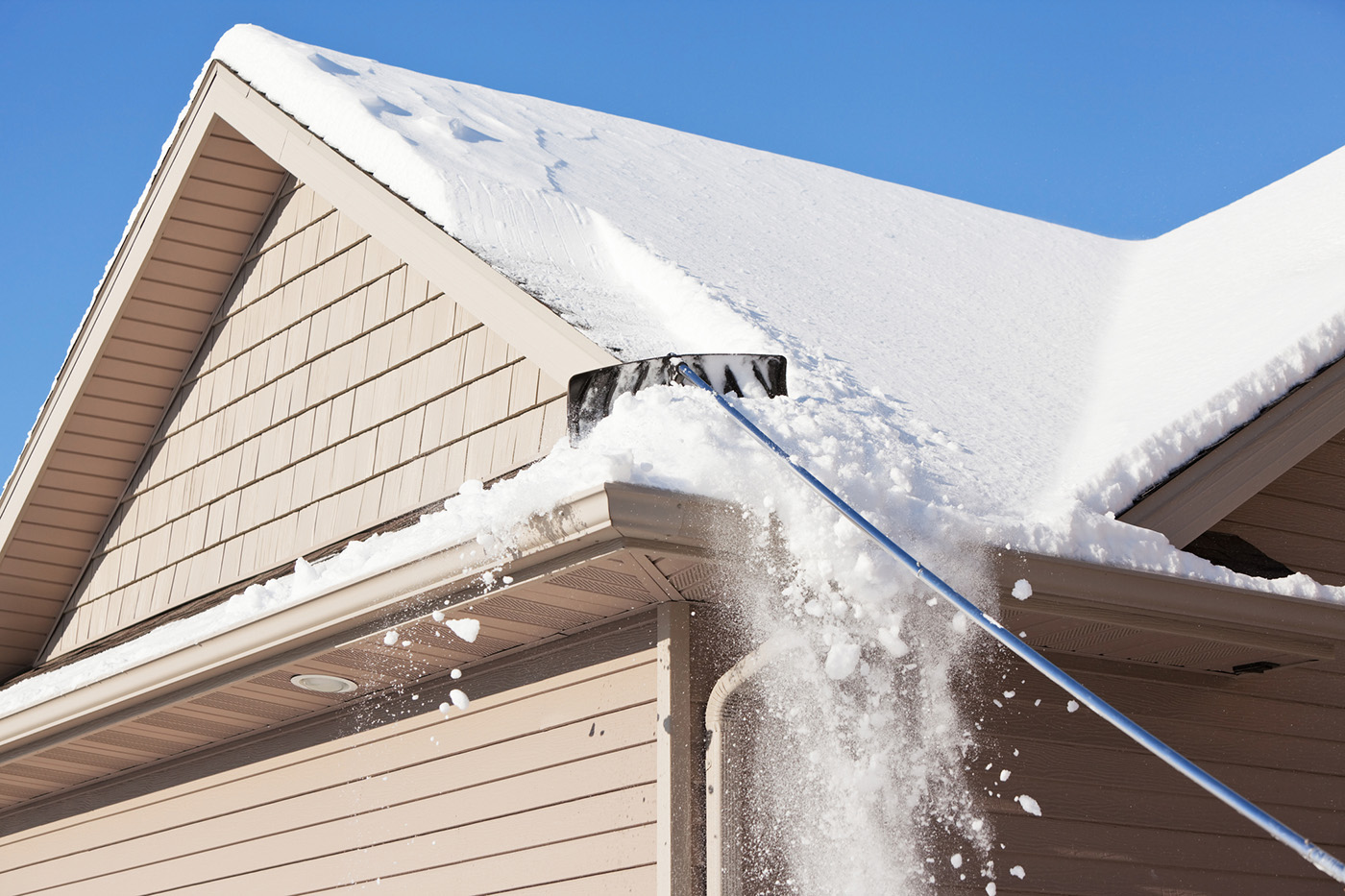 Crew removing snow from a rooftop