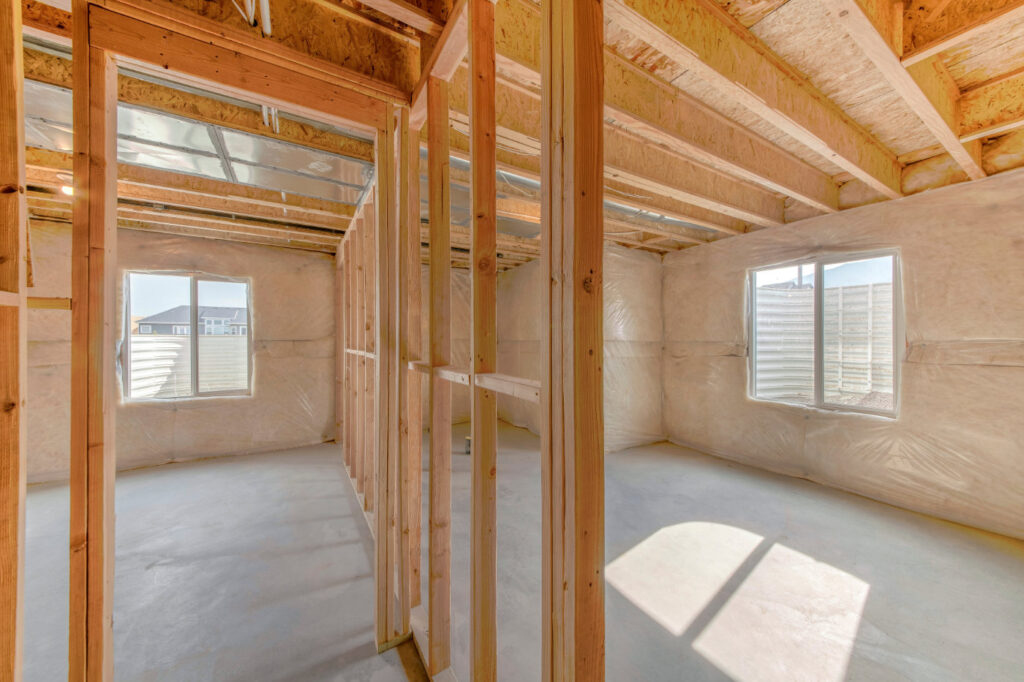 Unfinished basement with vapour barriers, windows and insulated walls.