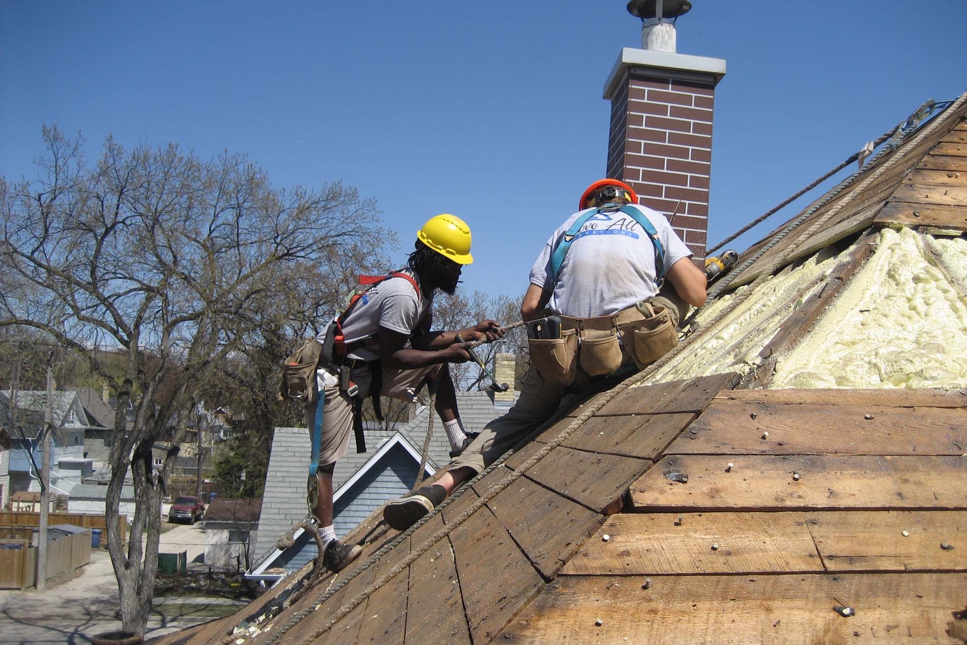 Crew insulating a heritage home roof