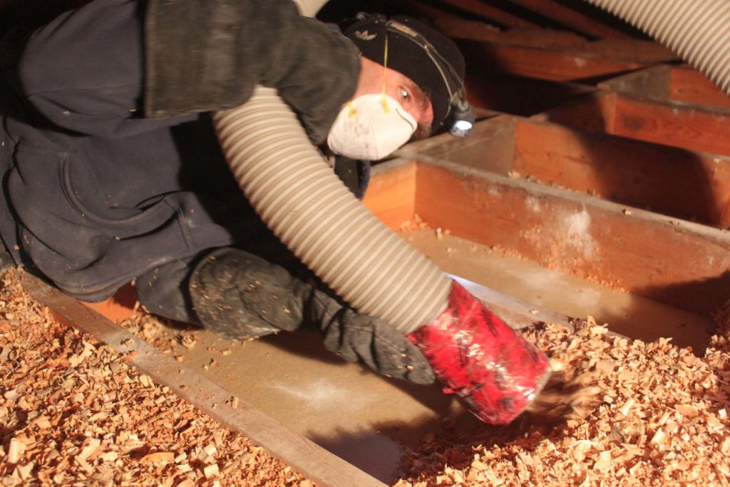 Wood shavings being removed in preparation for 2" polyurethane spray foam vapour seal.